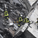 Rescuers at work amid the rubble after a highway bridge collapsed in Genoa.